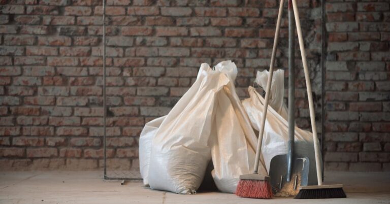 A post-construction space featuring cleaning supplies like a mop, bucket, and vacuum, surrounded by construction dust and debris, ready for professional cleaning.